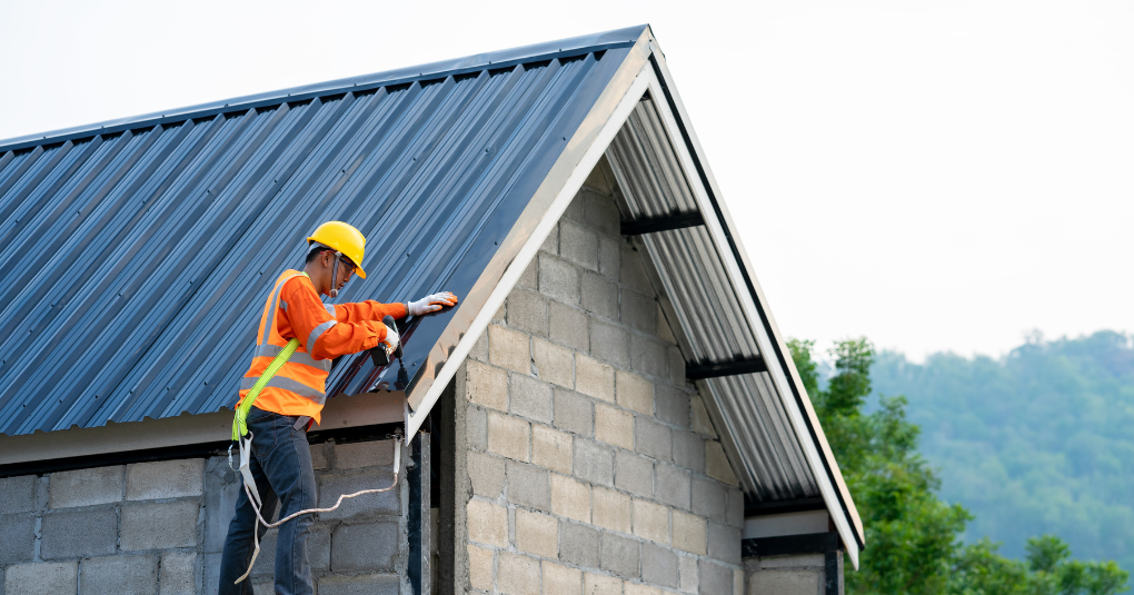 Roofer installing house roof.